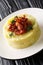 TrinxatÂ is a hearty mixture of cabbage and boiled potatoes, served with bacon closeup in the plate. vertical